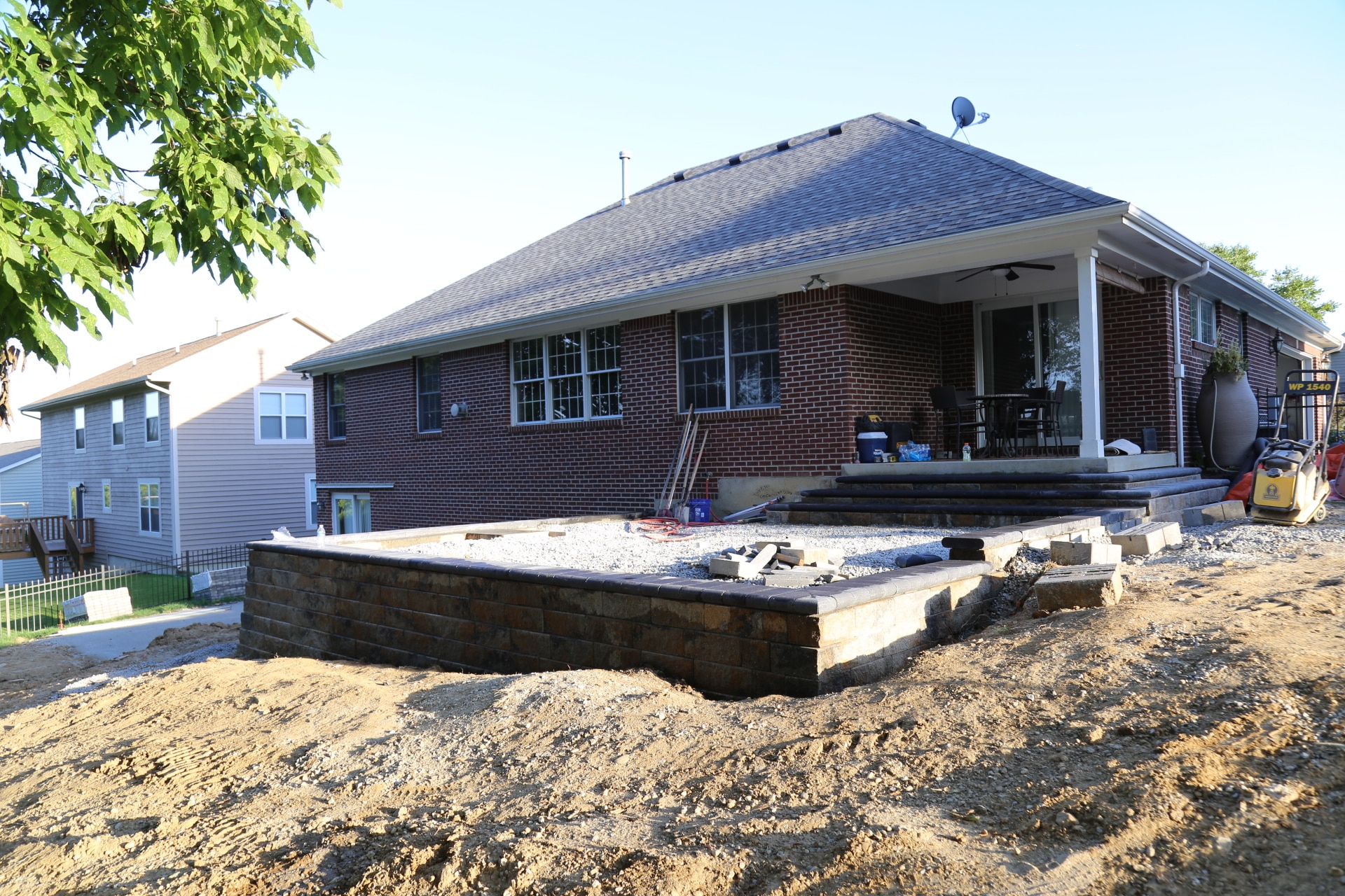 The slope of the yard made it impossible to install the upper patio with a positive slope away from the house foundation.