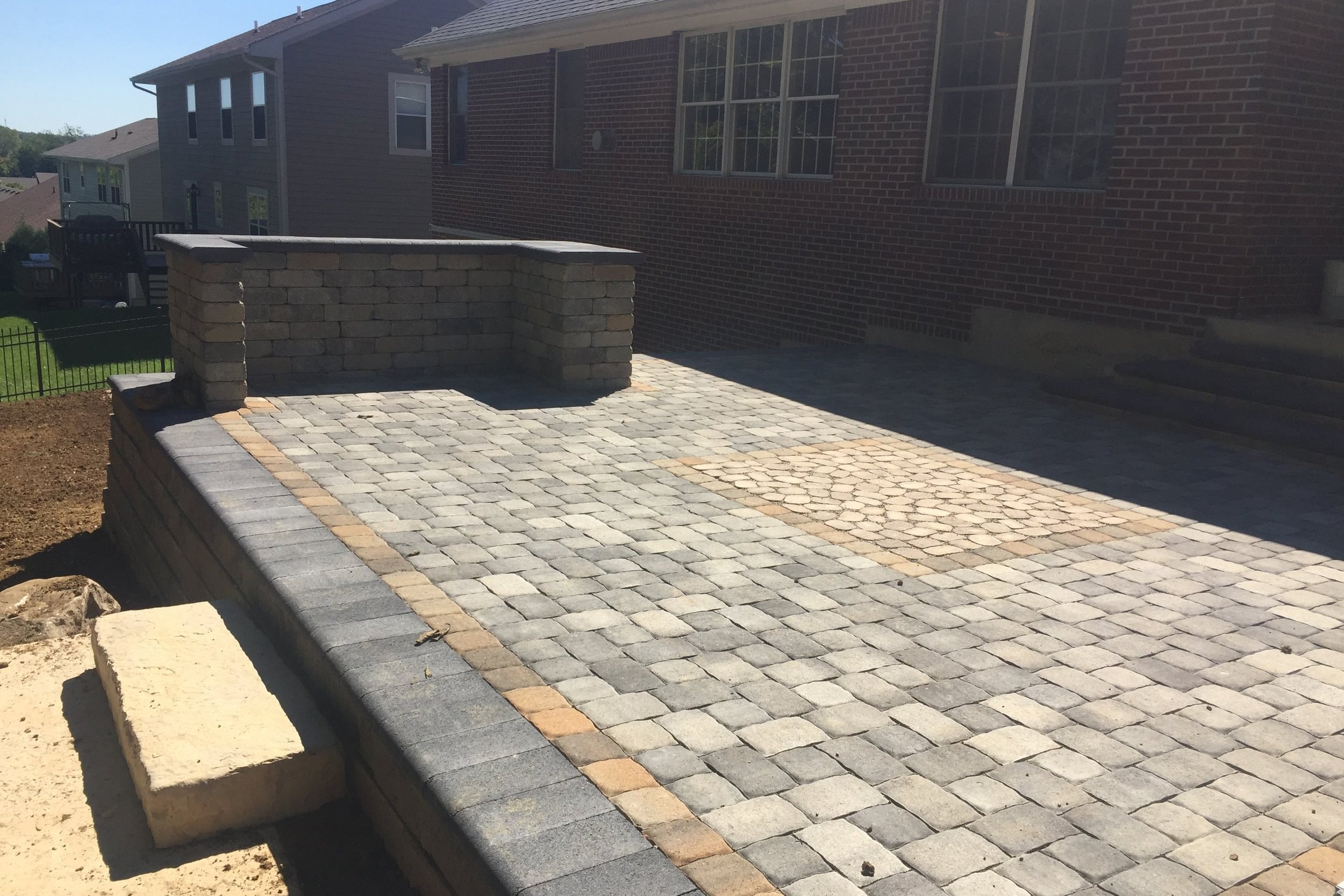 A permeable paver inlay was installed in the middle of the upper patio allowing runoff to drain down through the patio and into an underground drainage system.