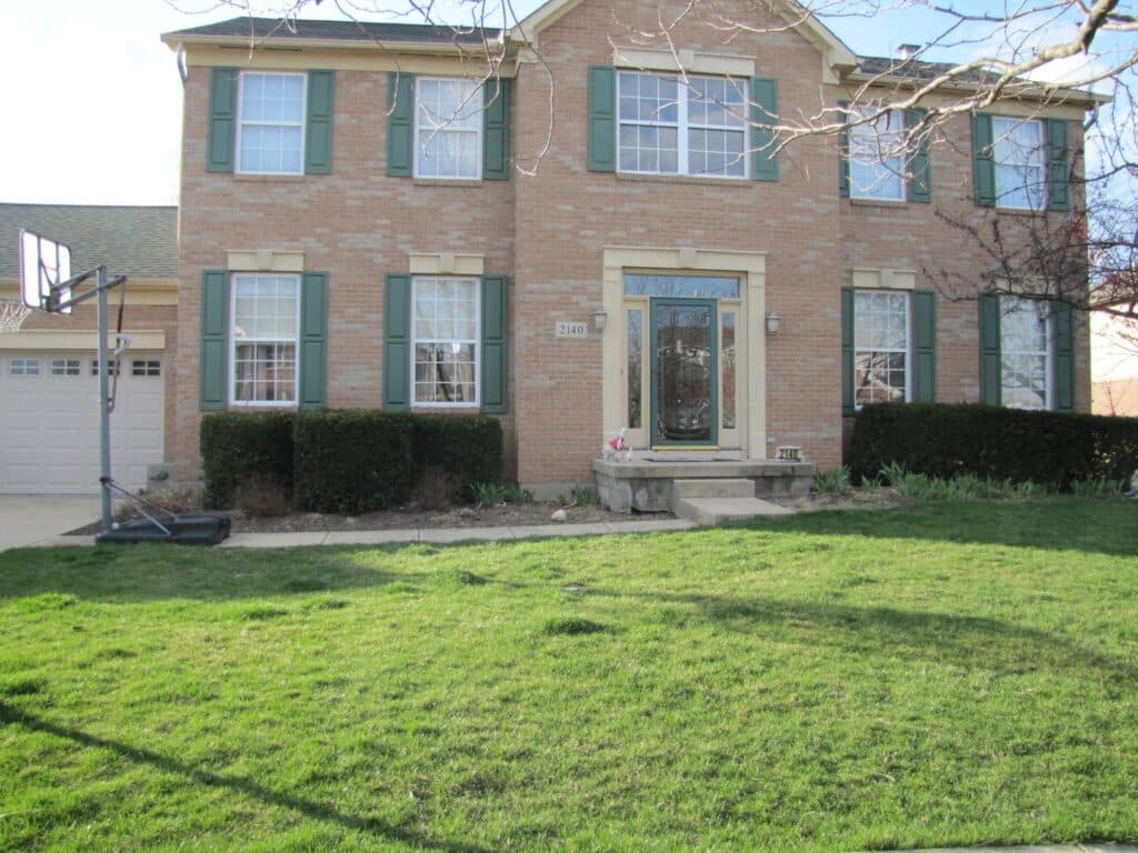 Before - This Beavercreek residence have overgrown plantings and a boring concrete stoop